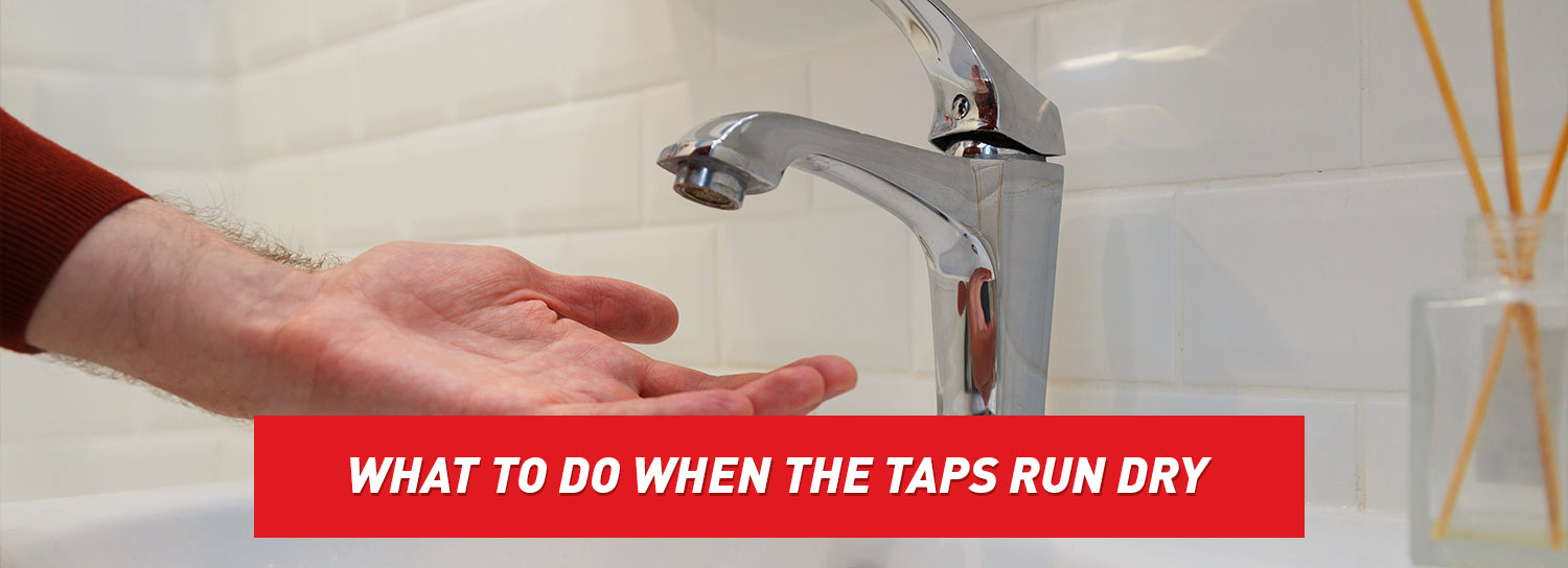 A person holding their hand under a faucet.