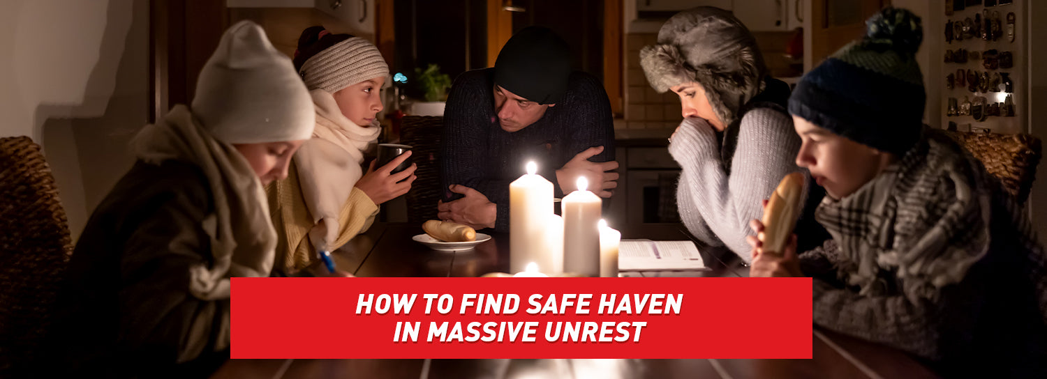 A family in warm clothes huddled together around a table with lit candles in the center.