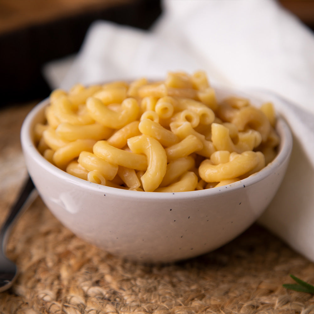 White bowl of classic macaroni and cheese