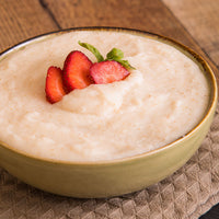 Thumbnail for Bowl of smooth hot strawberry cereal with fresh sliced strawberry garnish