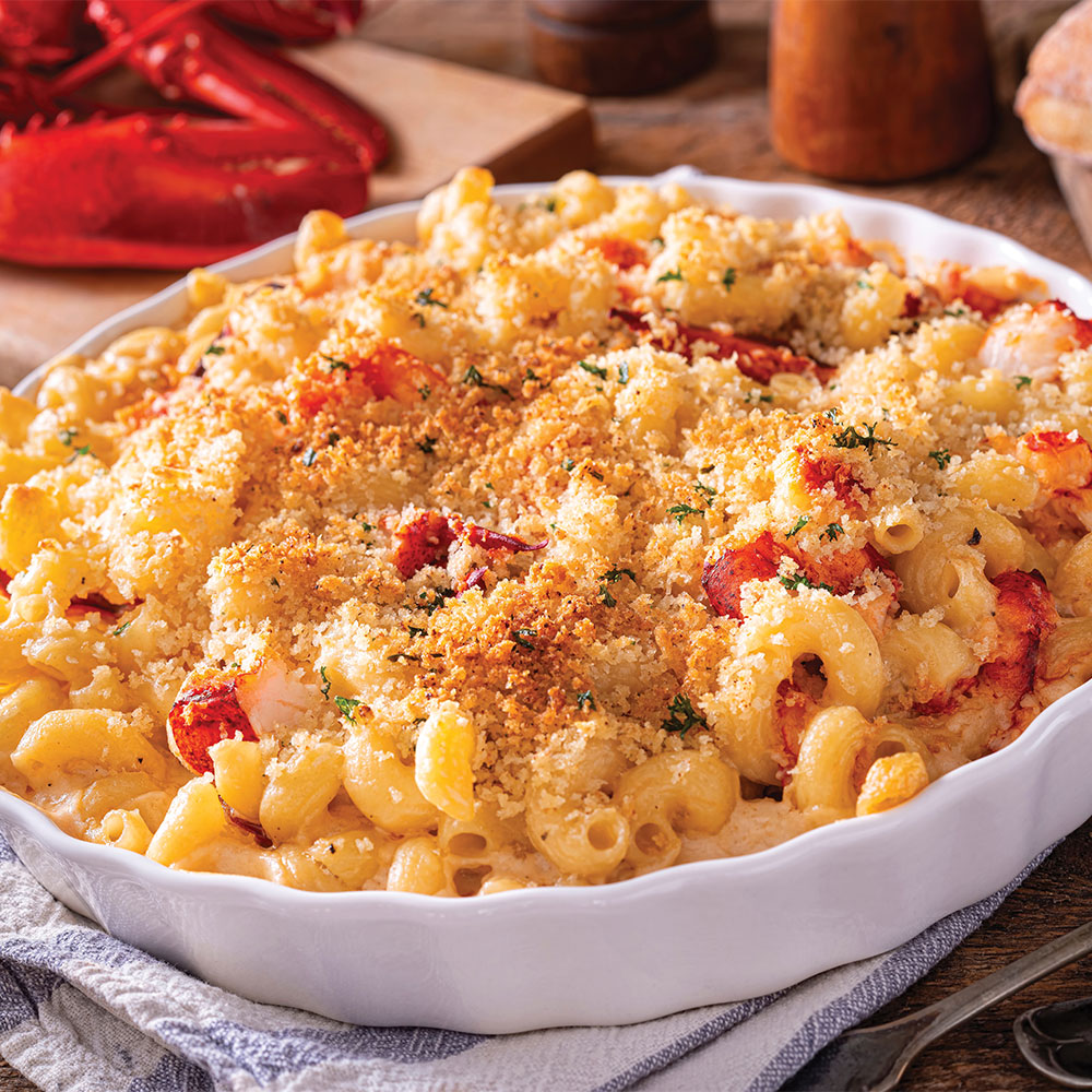 Elbow Macaroni baked into a macaroni and cheese casserole, sprinkled with tomatoes, bread crumbs, and spices.