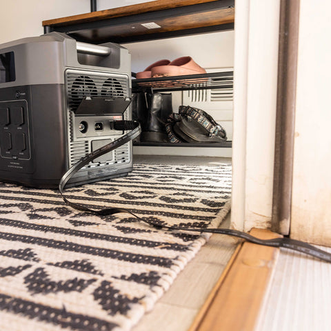 Image of Extension cord passing through a doorway for the 2200 & 3300 Solar Generators by Grid Doctor