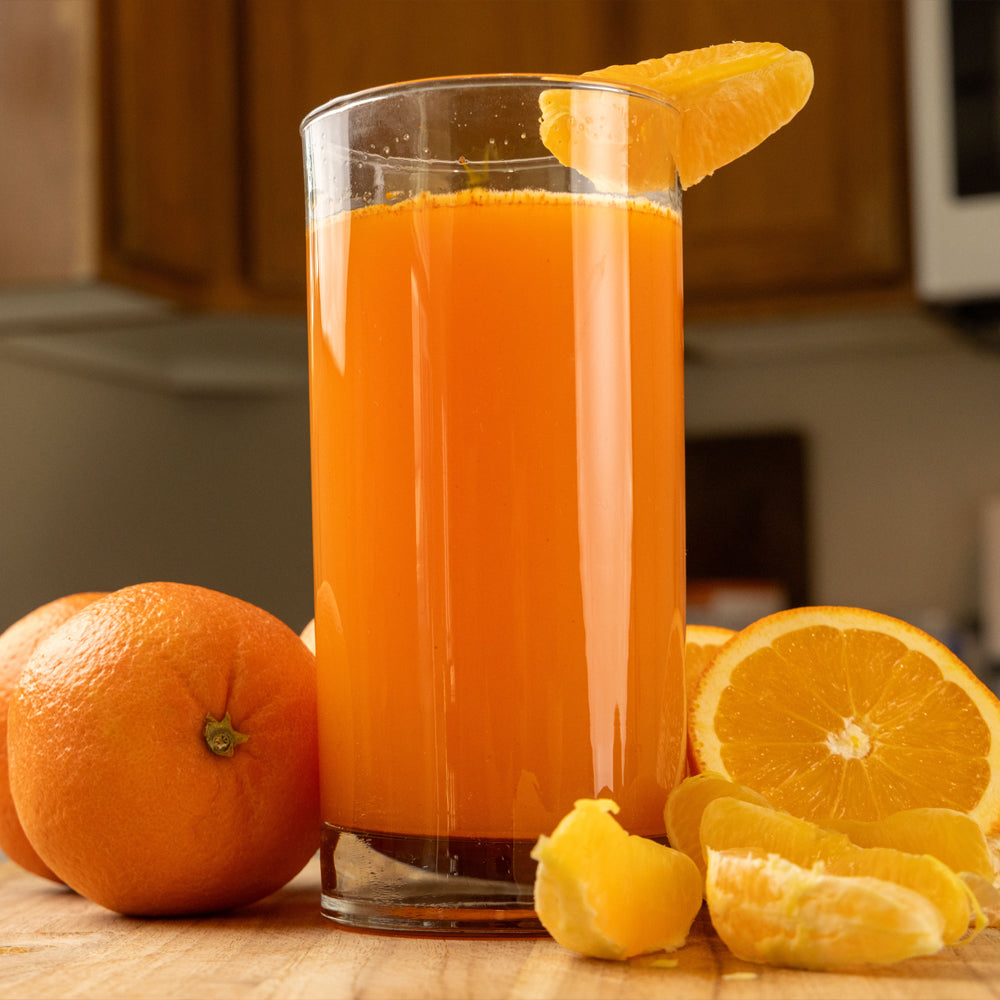 Ready hour orange energy drink in a tall glass with a sliced orange