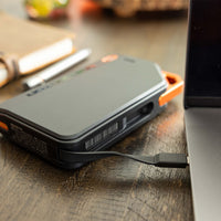 Thumbnail for Grid Doctor 65W Power Bank on a desk charging a laptop