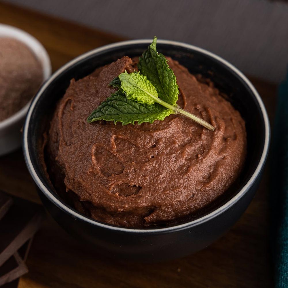 Dish of chocolate pudding with mint garnish on top