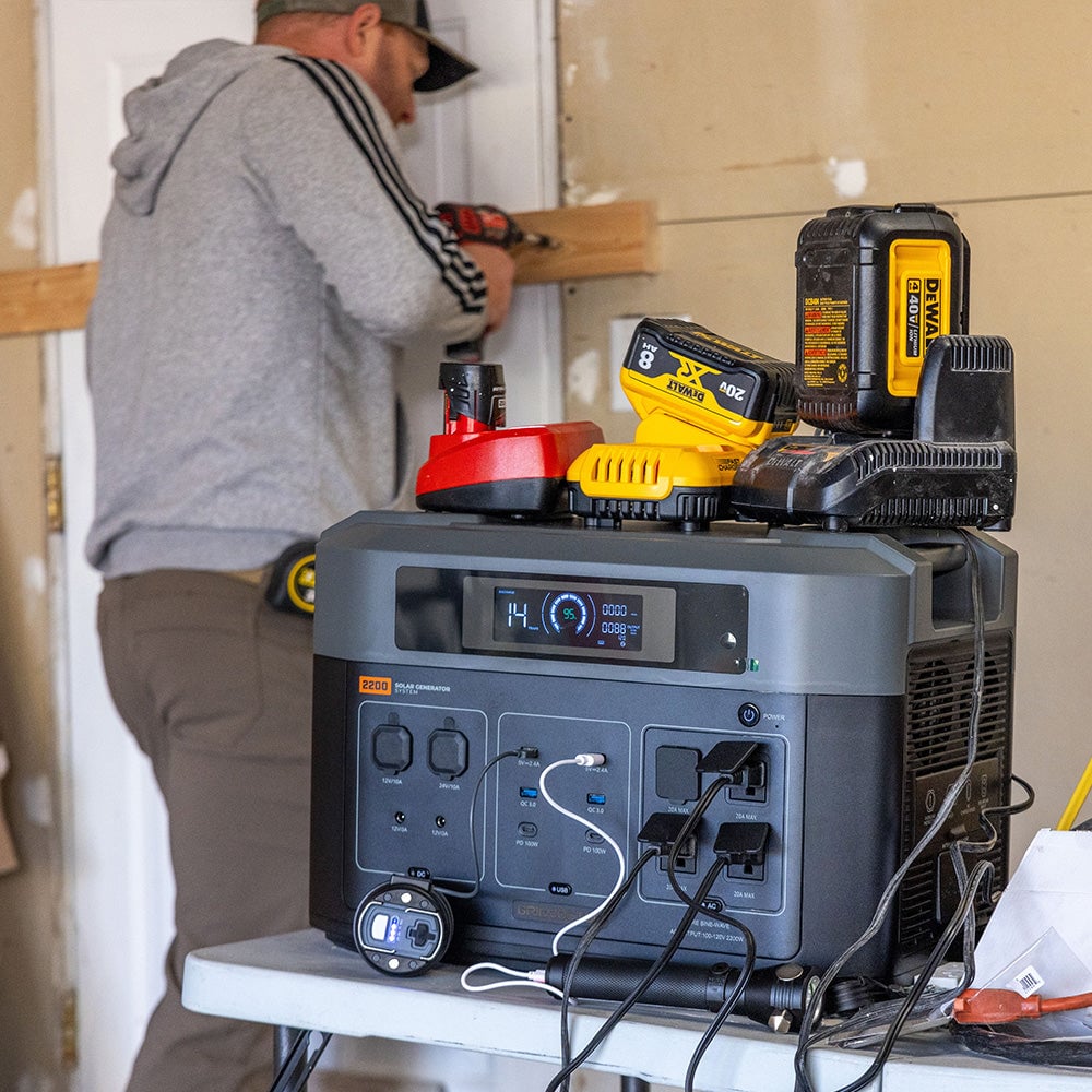 Shows the Grid Doctor system being used to charge power tools.